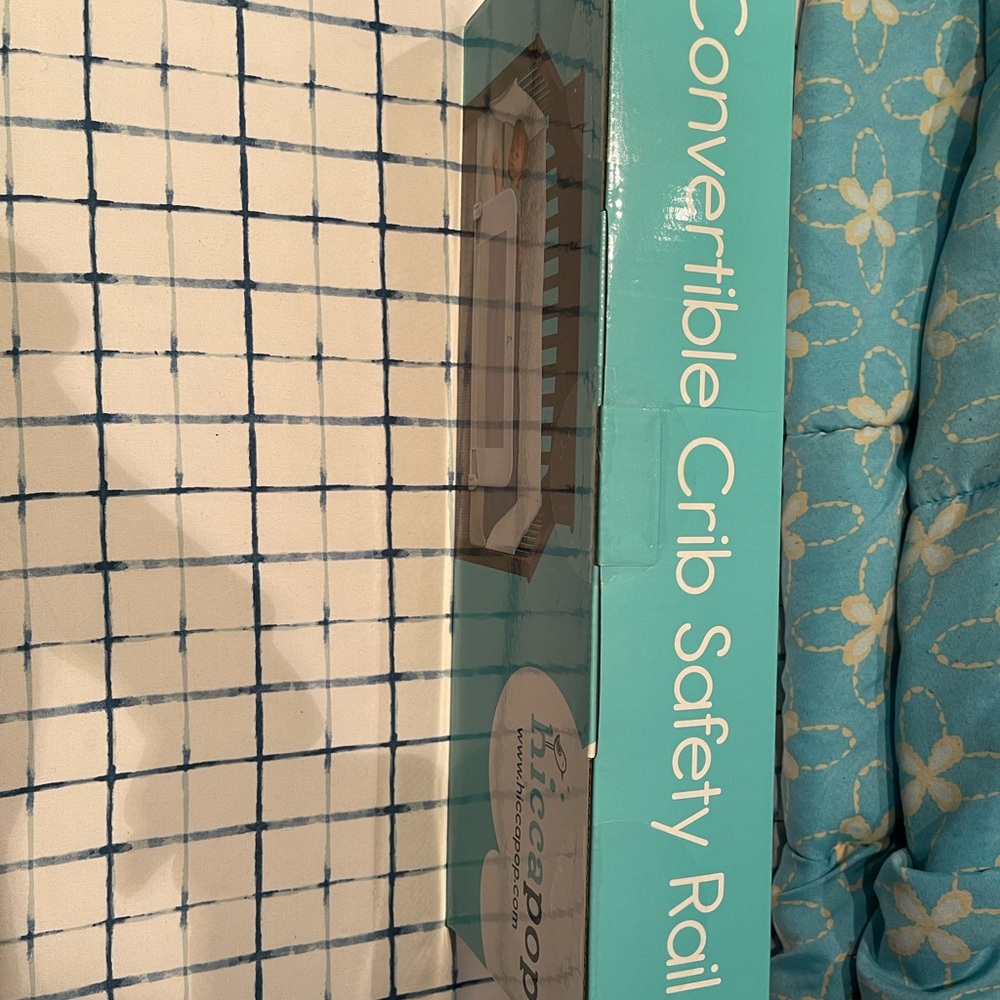 Never used in the box rail for baby bed